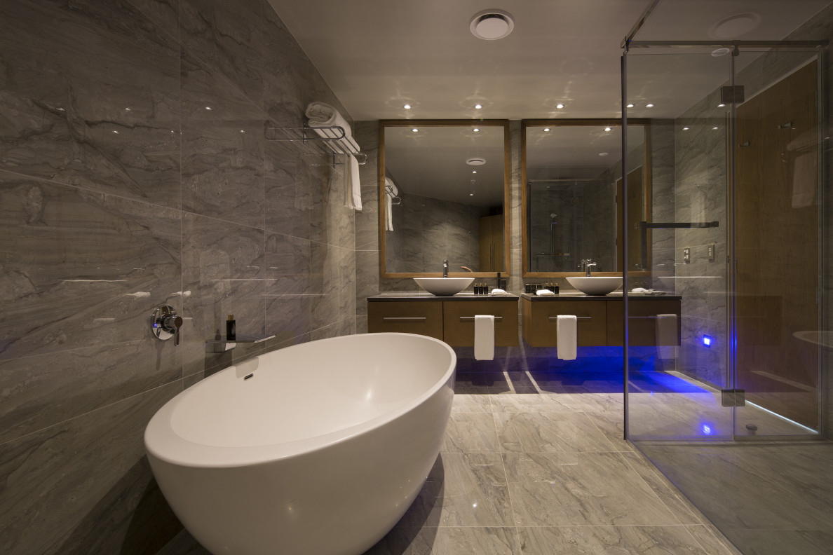 Grey marble bathroom with freestanding tub tiled by Parkway Flooring