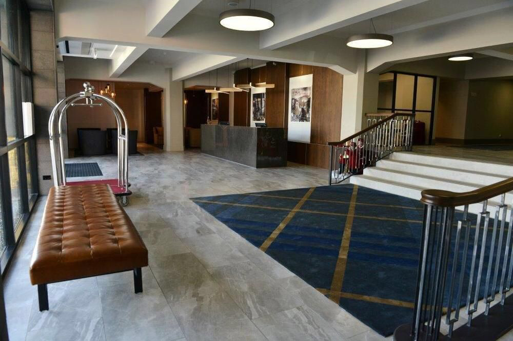 Commercial lobby with a large-format stone tile floor laid by Parkway Flooring