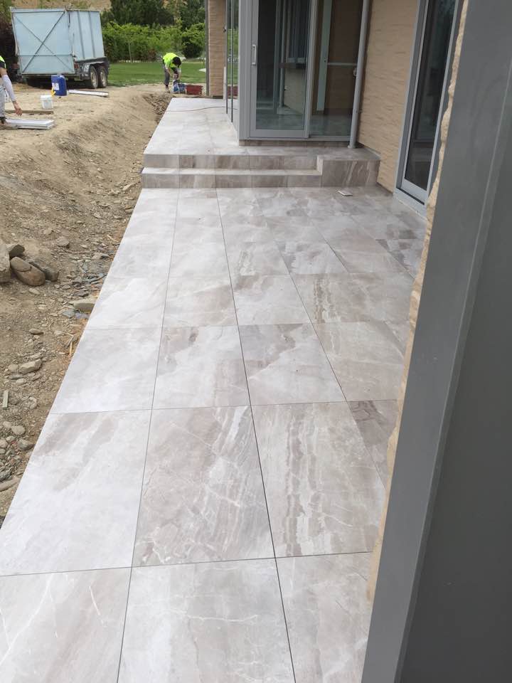 Large-format exterior stone paving beside a house
